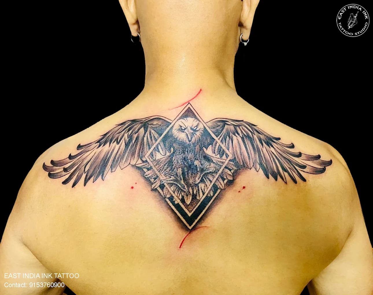 Majestic eagle and geometric mandala upper back tattoo