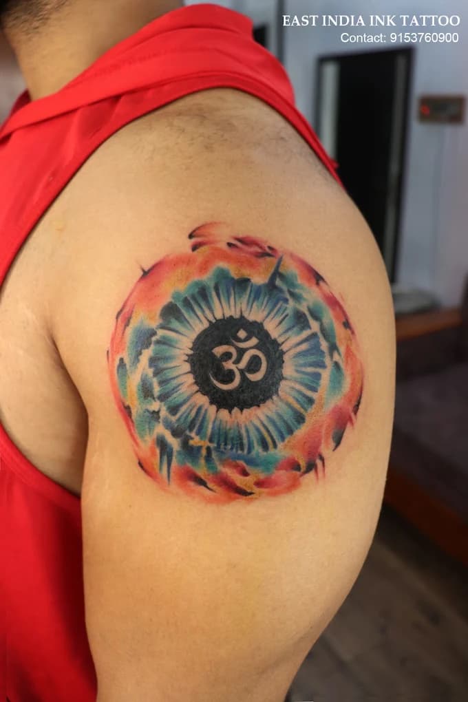 Cosmic Om and chromatic iris chest tattoo